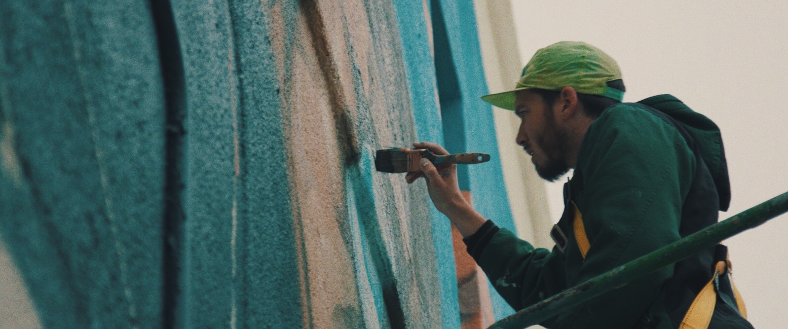 Dan Black painting a mural